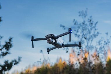 Compact drone with camera in the air in nature in autumn. High quality photo