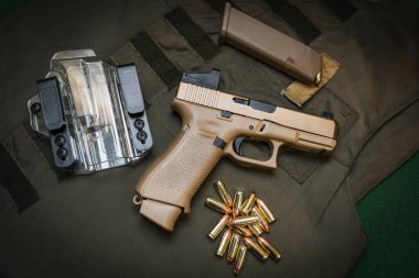 Firearm, military modern pistol with red dot sight, transparent holster, cartridges and body armor. High quality photo
