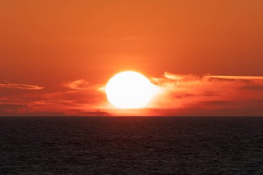 Summer sunset on the sea, photo with a telephoto lens with high magnification. High quality photo