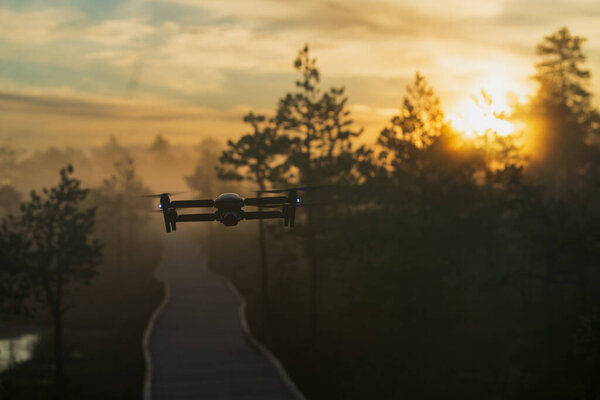 Drone in the air in nature at sunrise. High quality photo