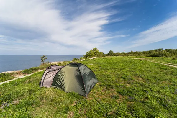 Outdoor recreation with a tent in the summer by the sea on a cliff in Paldiski. High quality photo