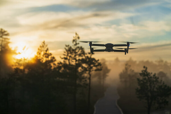 Drone in the air at sunset in nature. High quality photo