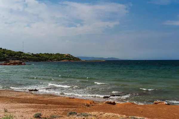 Greek brown sand beach in Varkiza in autumn. High quality photo