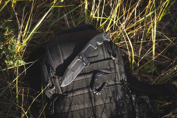 Tactical folding knife for outdoor survival in the fall. High quality photo