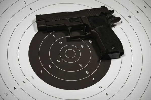 Classic shooting target and 9-mi pistol, close-up photo. High quality photo