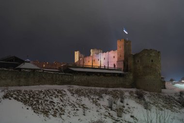 Night scene, ruins of Rakvere castle and cloudy sky.  clipart