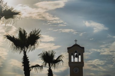 Atina 'da çanı olan palmiye ağaçları ve kilise kulesi. 