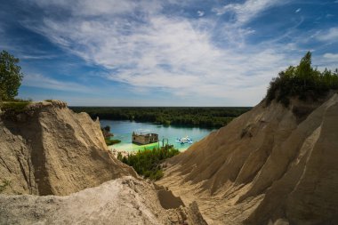 The best place for diving and snorkeling in Estonia is the Rummu quarry with an underwater prison. Photo view from the hill on a summer day.  clipart