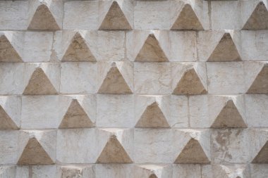 Fotoğraf arkaplan dokusu, şişkinlikleri olan ilginç beton bina cephesi. 