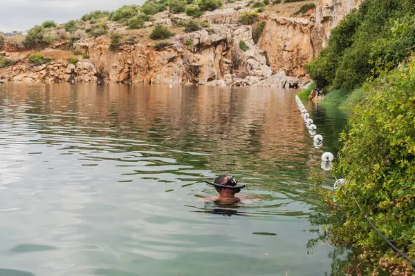 stock image A man snorkels on Lake Vouliagmeni on a summer day. 