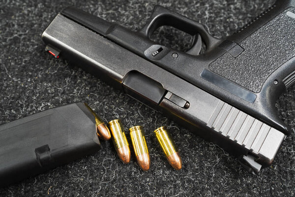 9mm pistol and cartridges, firearms, close-up photo. 