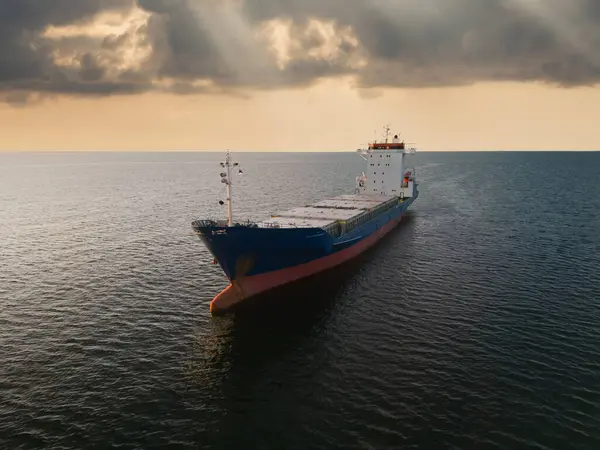 stock image An unloaded container ship anchored in the Baltic Sea at sunset in summer, photo view from a drone. 