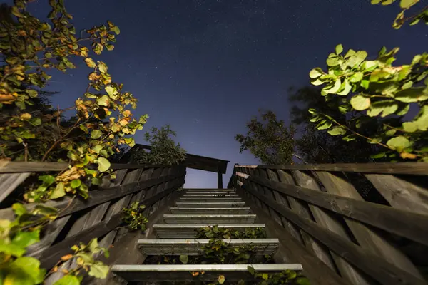 stock image Night scene, nature of Estonia in August. Stairs to the sea in Paldiski, starry sky.