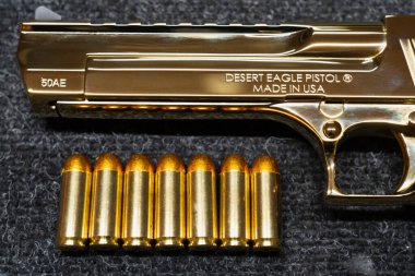 Baltics September 14, 2024. Desert eagle pistol and cartridge. 50AE caliber 12.7mm. Photo close-up. clipart