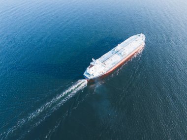 A large gas tanker vessel sails in the Sea, drone aerial view. clipart