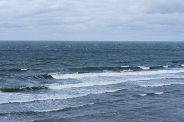 Baltic Sea: panorama of waves captured by a telephoto lens on a cloudy day. clipart