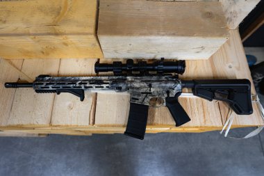 Optik görüşü olan bir keskin nişancı tüfeği ahşap paletlerde yatar..