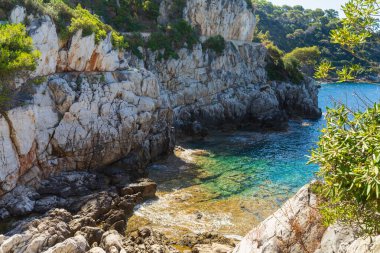 Sersemletici kayalık kıyı şeridi ve Saint-Jean-Cap-Ferrat 'ın kristal berrak turkuaz suları, Fransız Rivierası, altın güneş ışığıyla yıkanmış, lüks bir Akdeniz kaçışı için mükemmel..