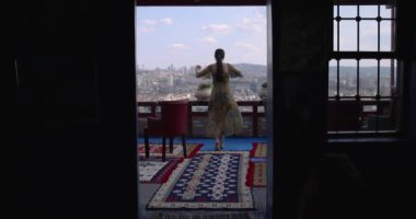 Camera Approaching Woman Dancing on Balcony with Perfect View from Dark Room 4K Slow Motion