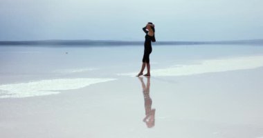 Woman Wearing Black Throws Her Hair In The Air Over Salt Lake 4K Slow Motion