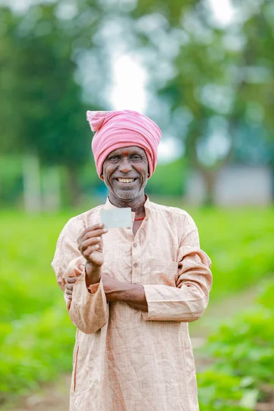 Indian farmer Holding ATM card in hands , happy indian farmer, poor farmer, worker