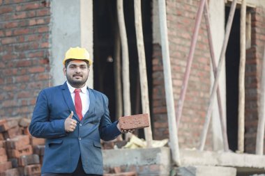 İnşaat şantiyesinde çalışan güvenlik üniformalı inşaat mühendisi portresi inşaat alanında inşaat işçisi kontrol ve kontrol projesi, yeni proje mimari mühendisliği.