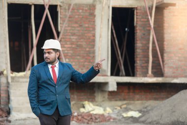 İnşaat şantiyesinde çalışan güvenlik üniformalı inşaat mühendisi portresi inşaat alanında inşaat işçisi kontrol ve kontrol projesi, yeni proje mimari mühendisliği.