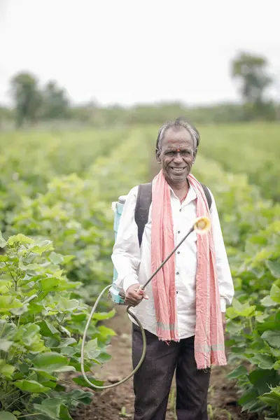 stock image Indian farmer holding spray pump in hand , farm worker