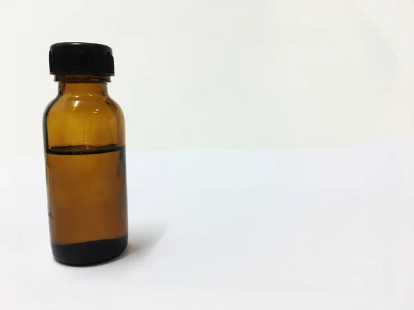 Glass bottle of tea tree oil isolated on white background.