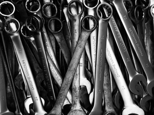 stock image Black and white photo of old multiple wrenches size hanging on tool board in auto car service and maintenance station workshop.