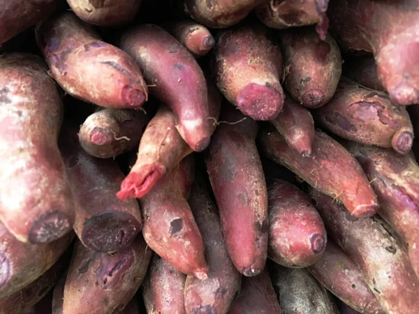 Purple sweet potatoes are dark-hued, sweet fleshed root and vegetable high in nutrients. It must be cooked before eaten and can be baked, fried, toasted, steamed, boiled, grilled, and more.