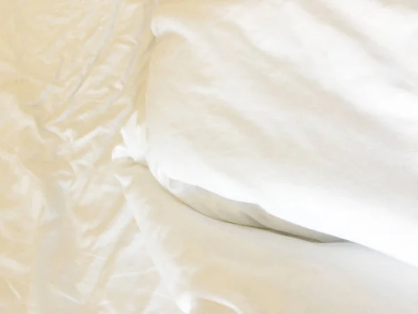 The crinkle blanket on the bed in the hotel with the sunlight on the blanket