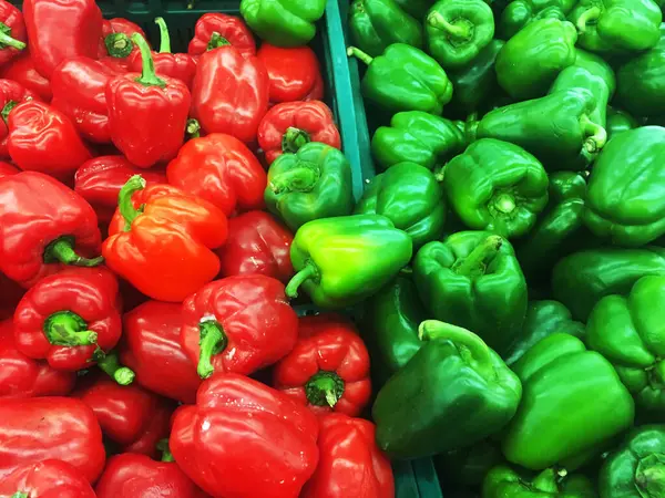 Red, and green bell pepper capsicum displayed for sell in fresh market.