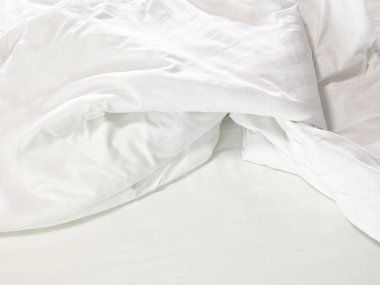 Yapılmamış yatak, kırışık yastık kılıfları, çarşaf ve yorgan..