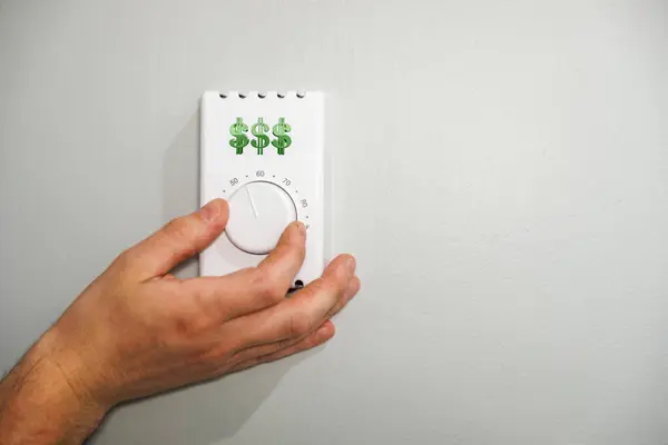 stock image Hand Adjusting Thermostat to Save on Heating and cooling Costs