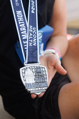 Runner Holding Medal After UConn Health Half Marathon 2024 Simsbury, CT clipart