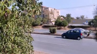 Güneşli bir kış gününde Ağaçlar Elektrikli Polonyalılarla ve Görünür Binayla Ana Bulvar 'da Trafik Hareketi. Rawalpindi Pakistan 31 Ocak 2025