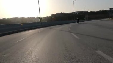 Virajlı köprü yolunda motosiklet dönemecinde hız ve köprünün mimari çizgileri ile hareket bulanıklığı