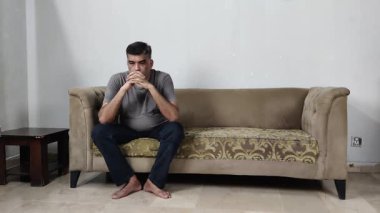 Endişeli Adam Koltukta Tek Başına Oturur Yere Bakar Çaresizliği ve Derin Duygusal Çatışmayı Yansıtır