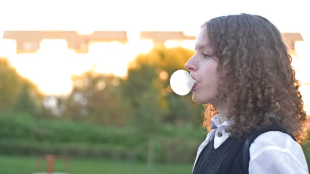 Curly Haired Teenage Girl Inflates Big Gum Bubble Bursts — Stock Video