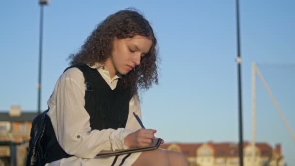 Cute High School Girl Writes Something Notebook Smiles — Stock Video