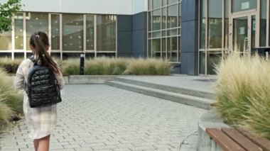 Group of elementary school students rush to a lesson to school. Back to school. 4K..