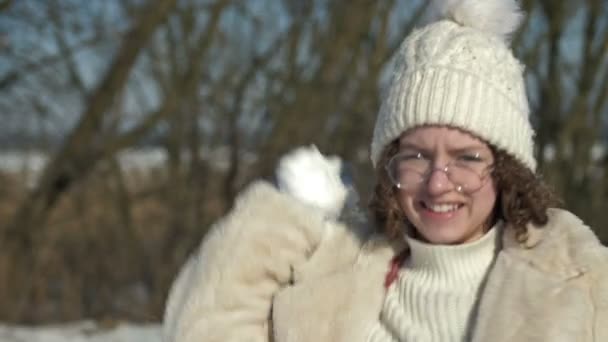 Веселая Девочка Подросток Белой Вязаной Кепке Очках Бросает Снежок — стоковое видео