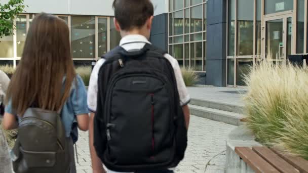 Négy Elsős Két Fiú Két Lány Közeledik Iskolaépülethez Iskolásoknak Játékos — Stock videók