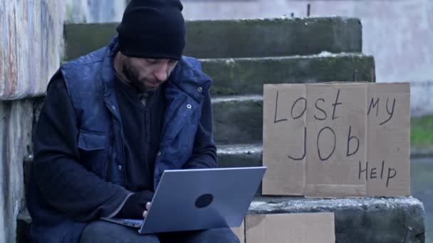 Homeless Man Shivering Cold Laptop Her Lap Sits Cardboard Amongst — Stock video