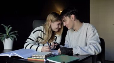 Two high school students, a boy and a girl, prepare for college lectures together. At the same time, teenagers listen to music. First love. 4K.