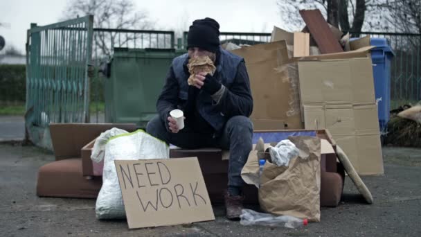 Cold Dirty Young Man Sits Pile Rubbish Eats Drinks Something — Αρχείο Βίντεο