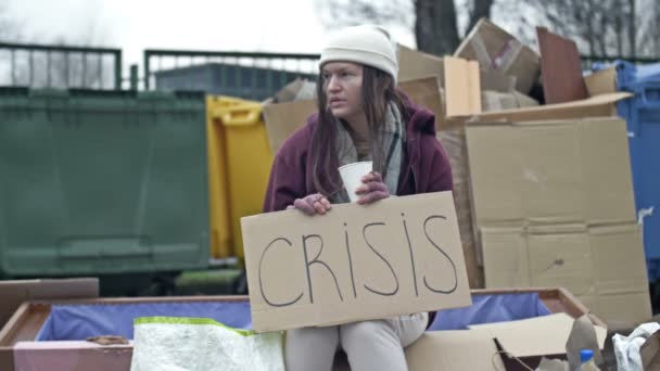 Cold Unkempt Looking Young Woman Sits Begging Cup Pile Rubbish — Stock videók