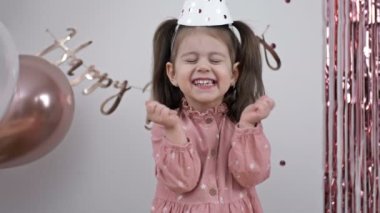 Little girl rejoices on her birthday. 4K.