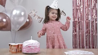 Little girl rejoices on her birthday. 4K.